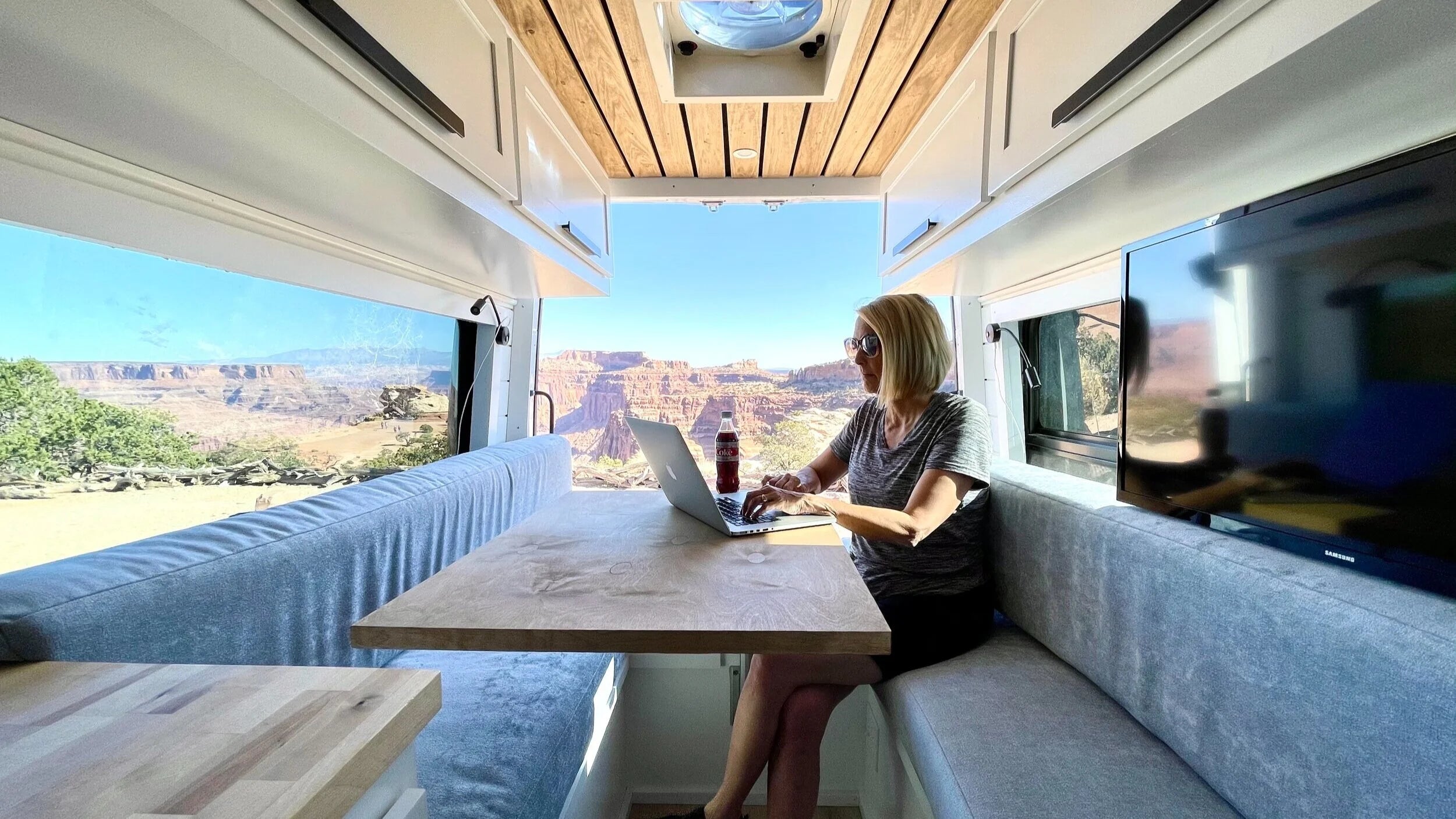 Custom camper van dinette interior by Thrive Crafted Vans